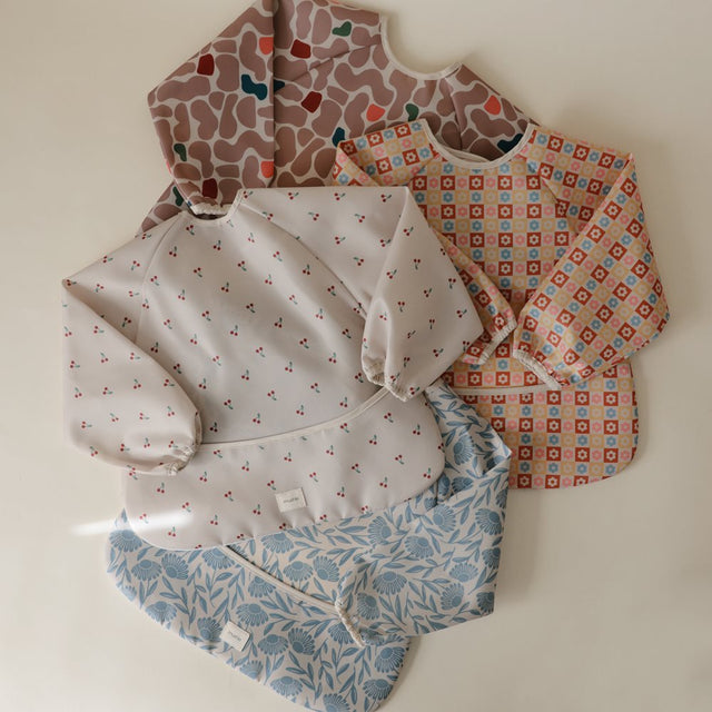 Mushie bib ar piedurknēm Blush