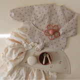 Mushie bib ar piedurknēm Blush